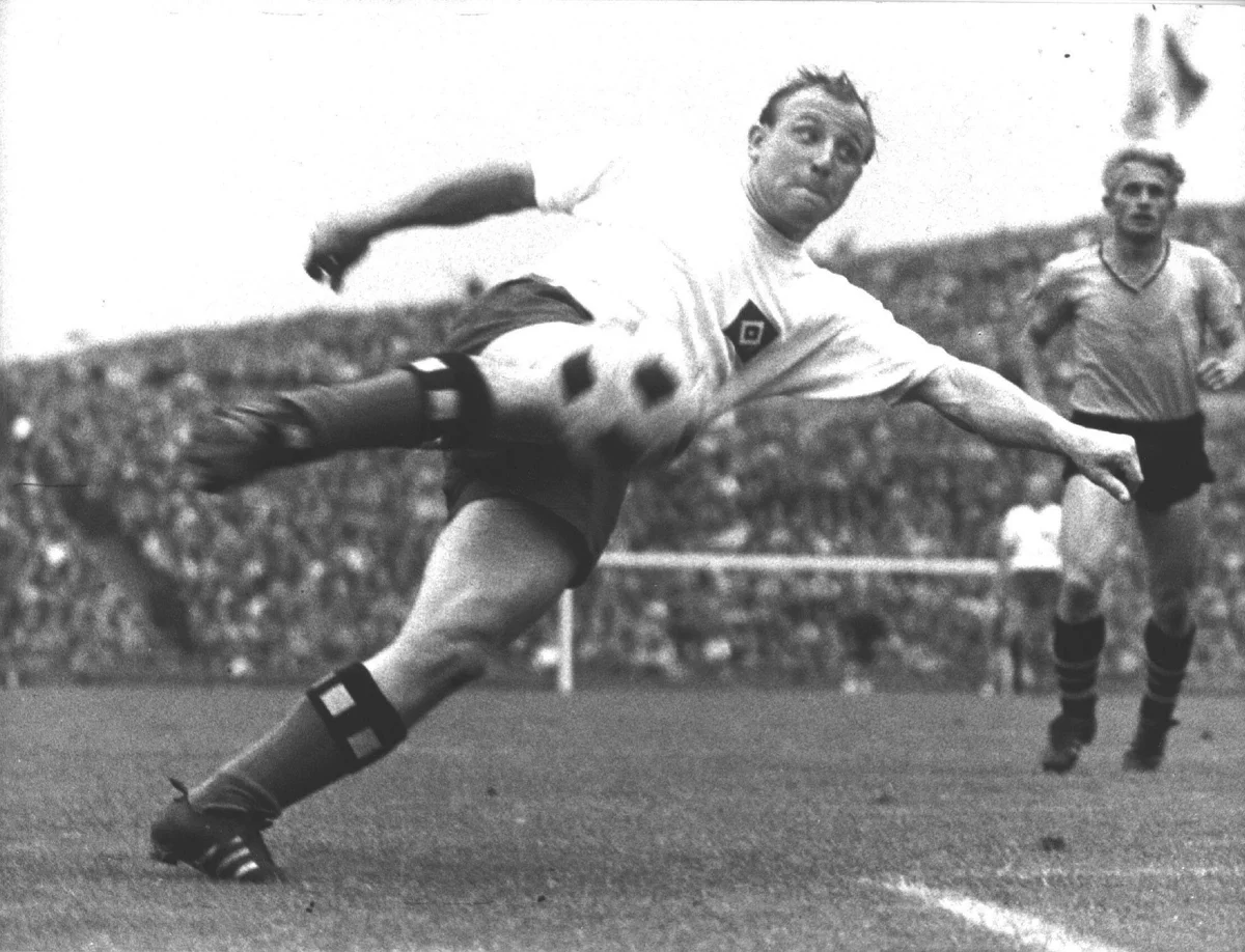 legendary german footballer scoring goal 1970s action shot