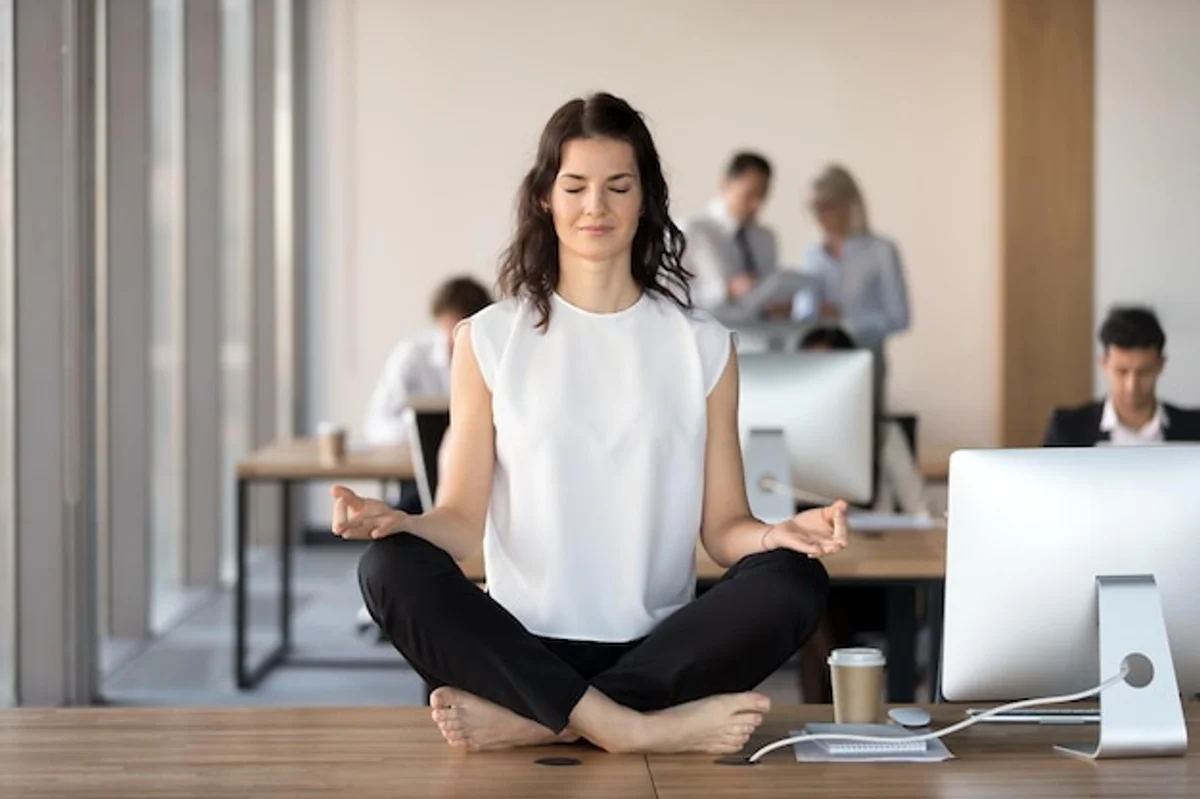 woman meditating stress relief office