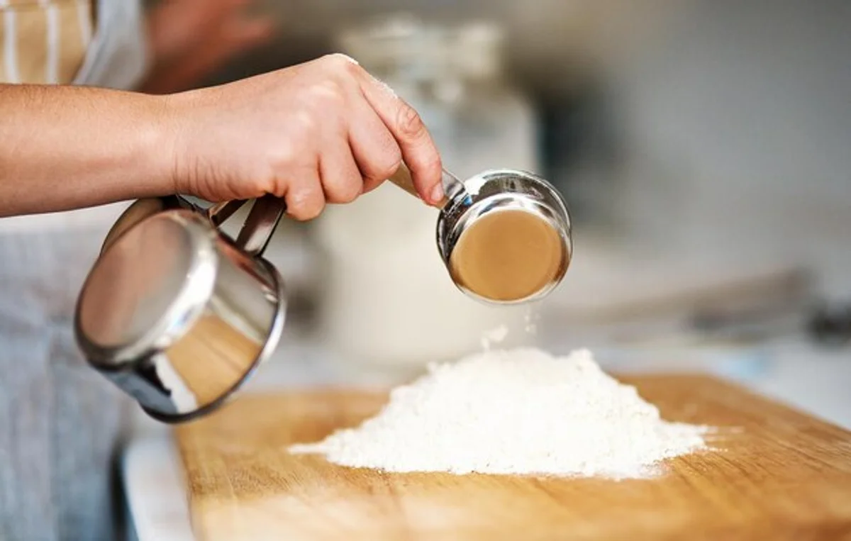Bread baker measuring salt with scale, home kitchen