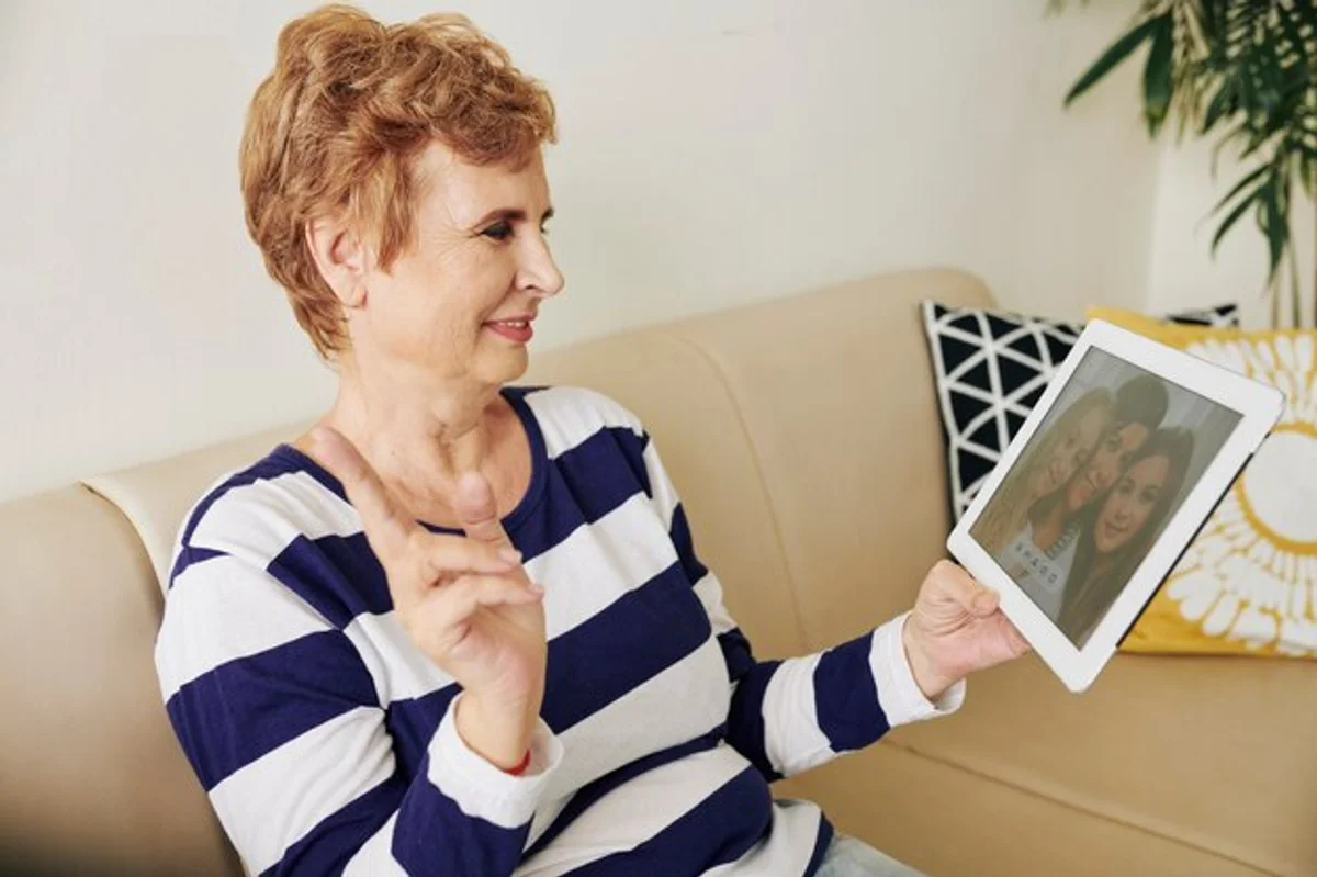 grandmother video calling family on tablet