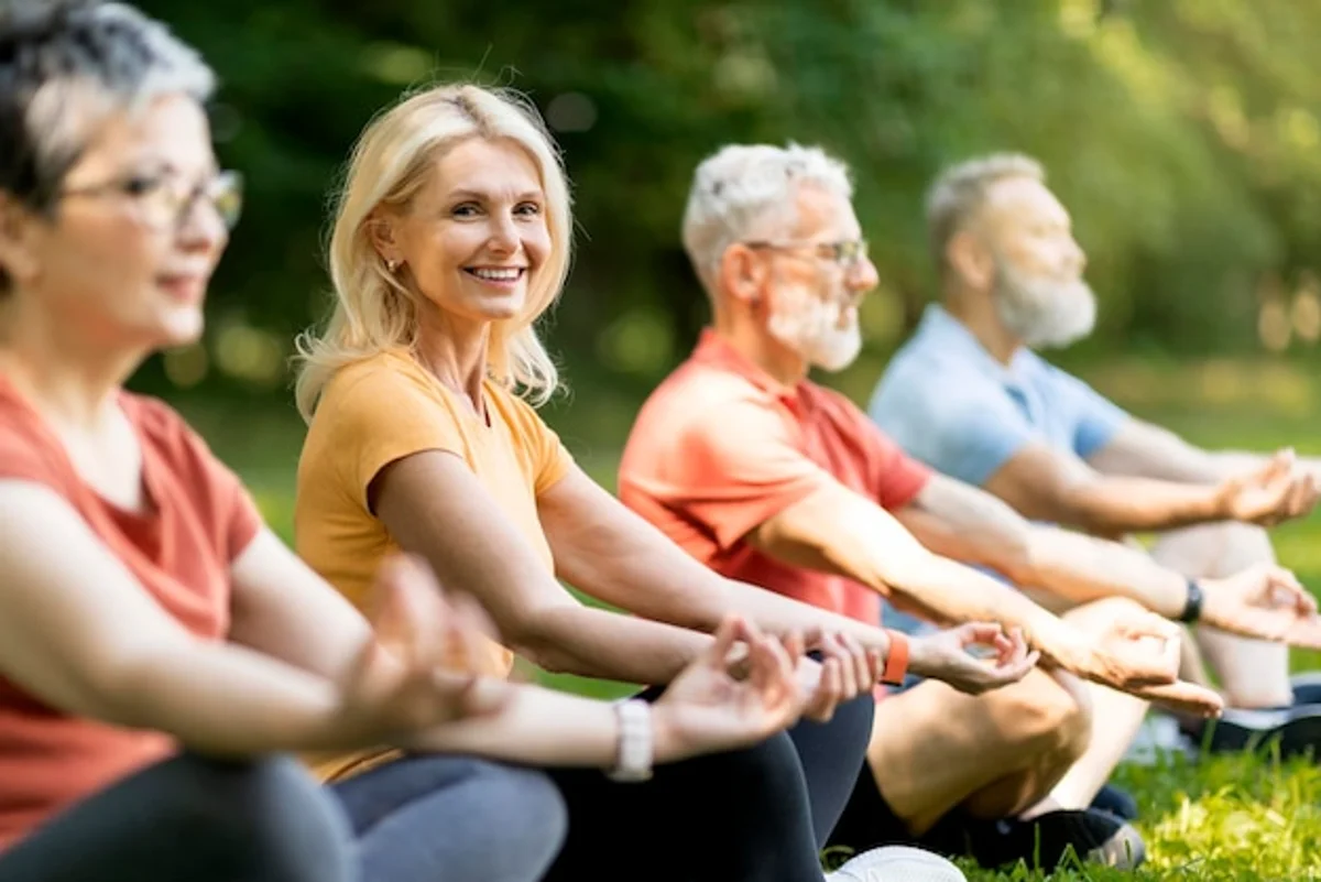 elderly yoga group smiling outdoors