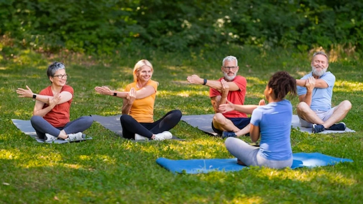 elderly yoga outdoors sunny park active seniors group