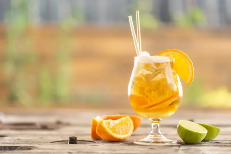 refreshing summer beer with lemon and ice outdoors