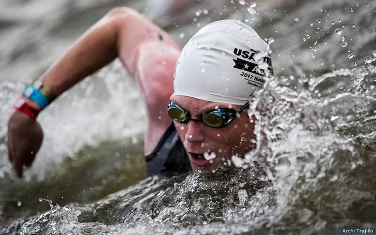 tired amateur swimmer catching breath after sprint competition pool