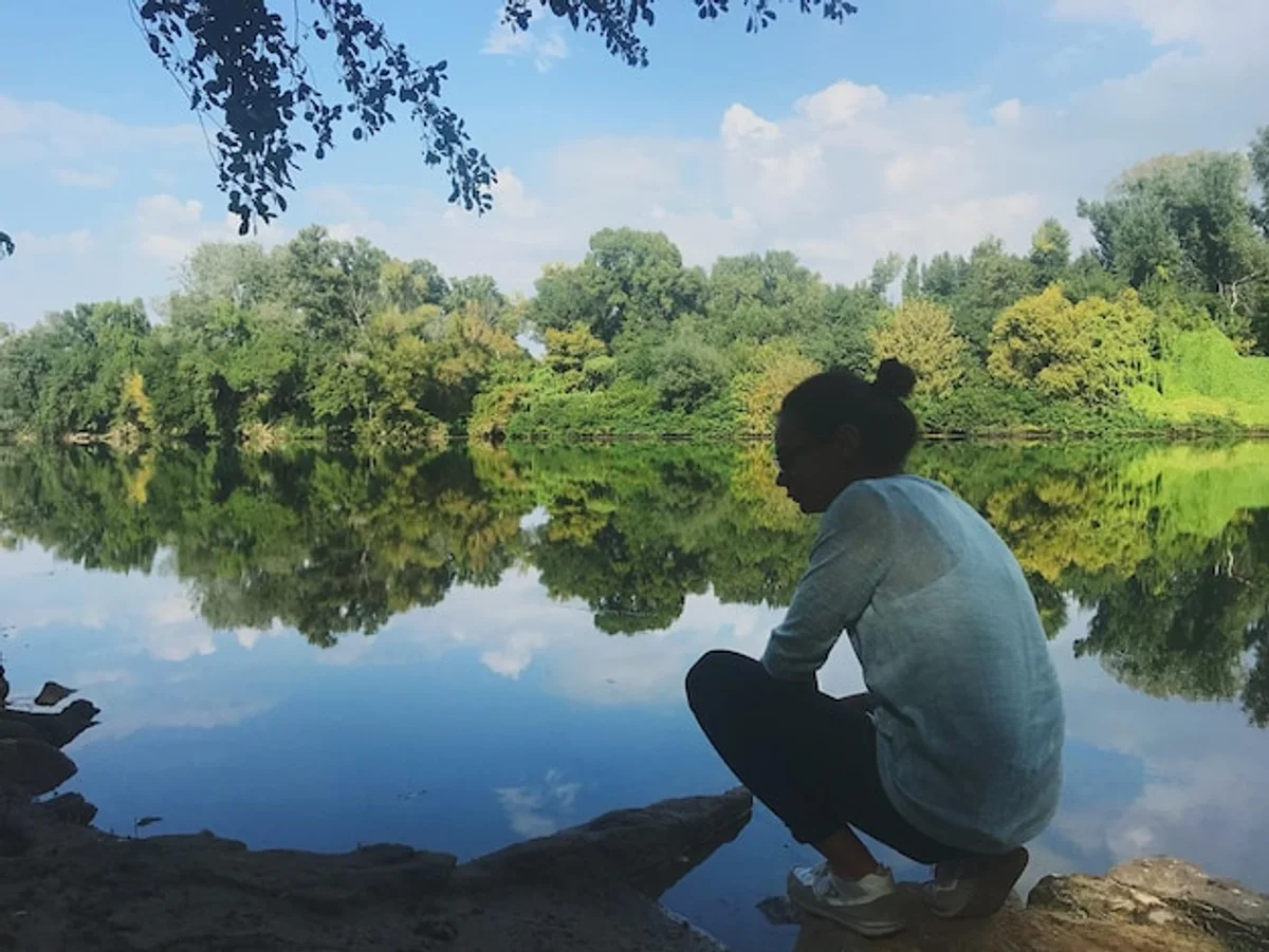elderly woman water reflection lakeside in nature