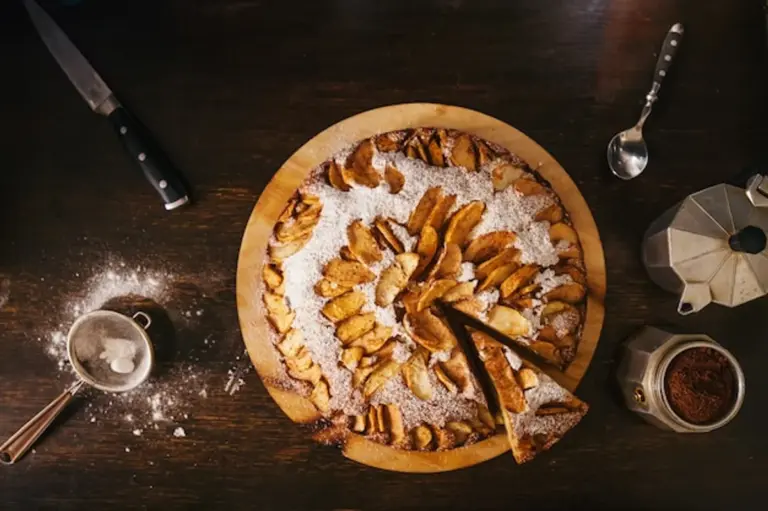 german apple cake with creme fraiche on rustic table