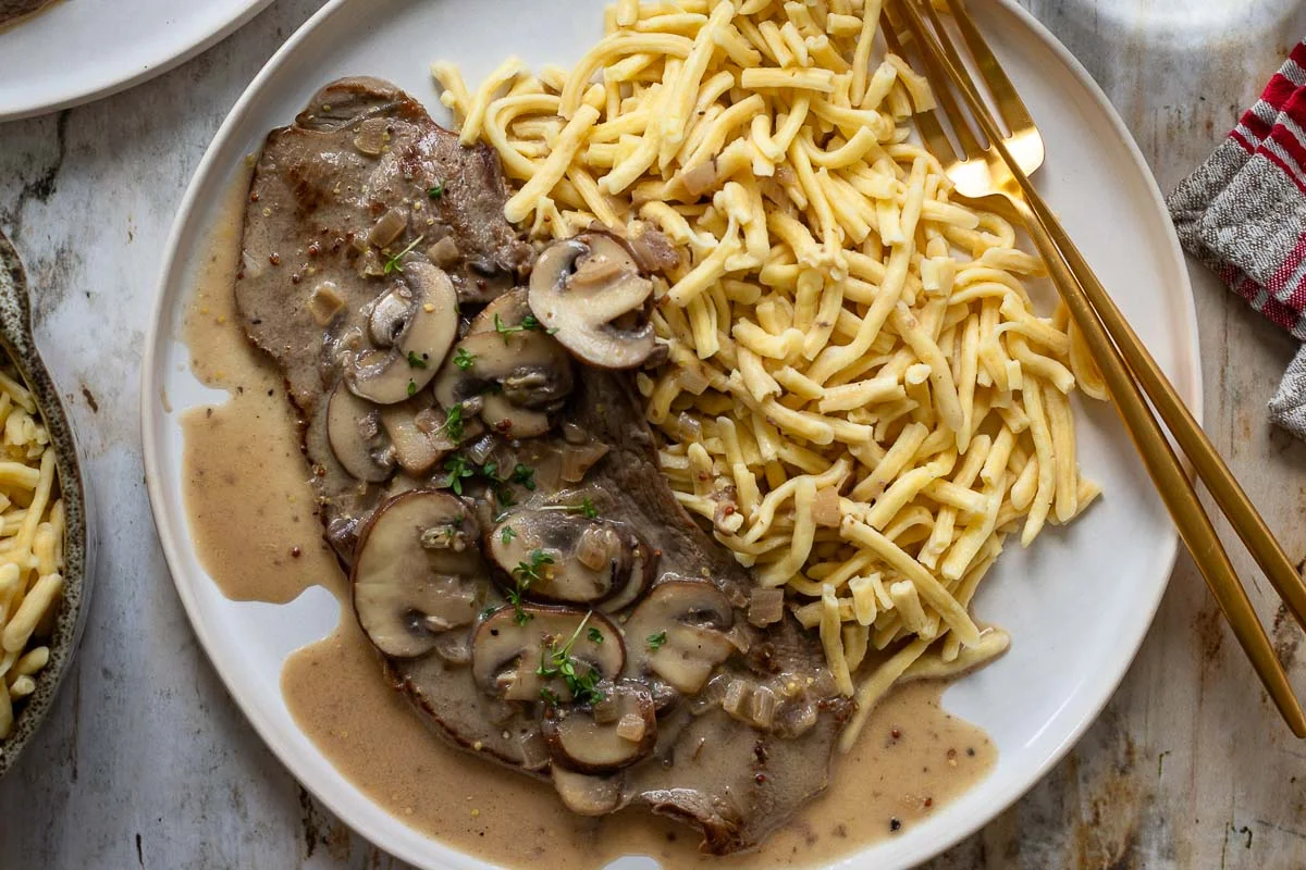 jägerschnitzel with creamy mushroom sauce and parsley, close up