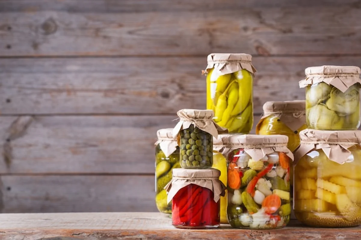 homemade fermented vegetables in jars on wooden table