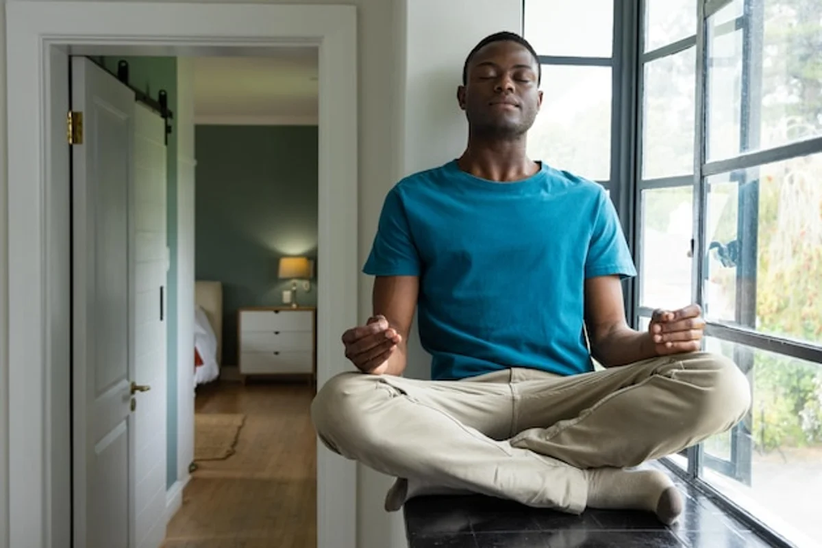 person practicing mindful breathing at home morning window