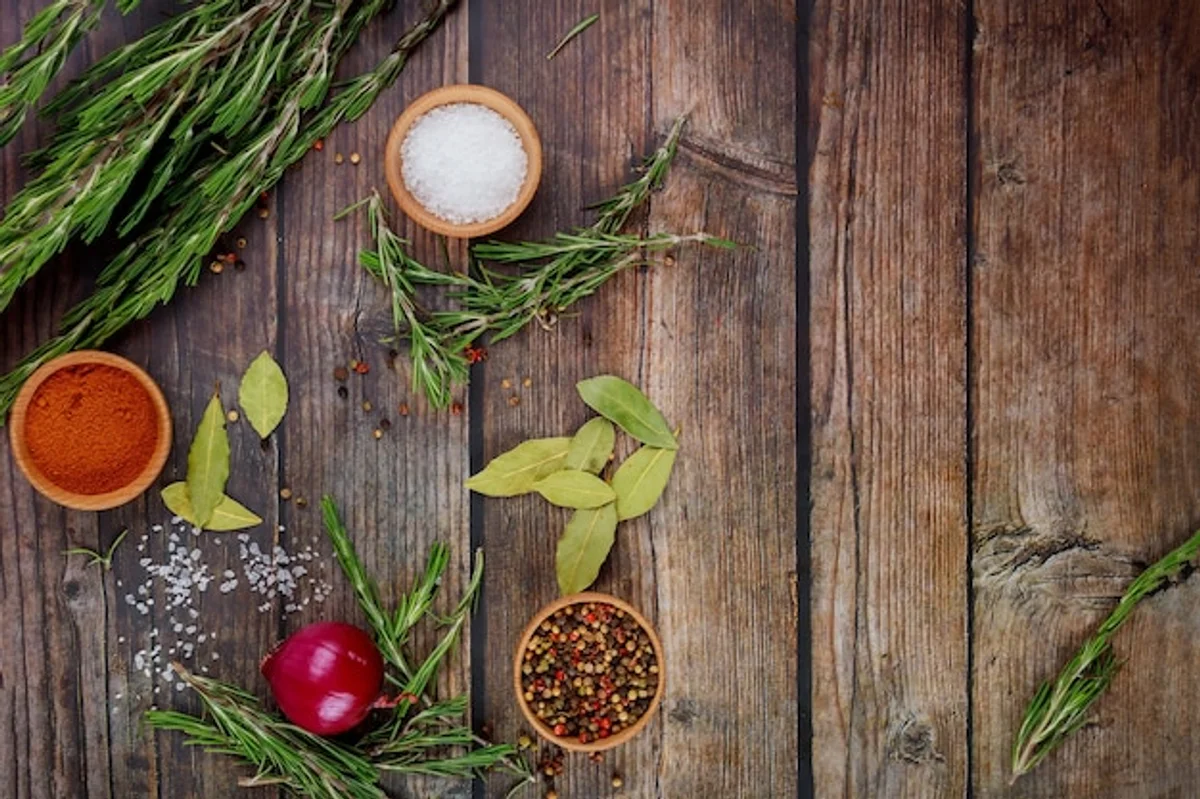 fresh herbs and spices on rustic wooden table