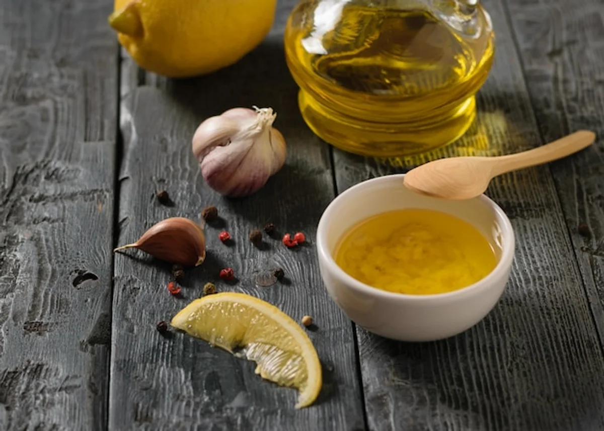 lemon zest and freshly cut herbs next to a salad bowl