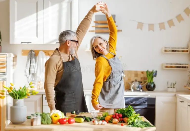 happy senior couple cooking modern twist traditional German dish kitchen