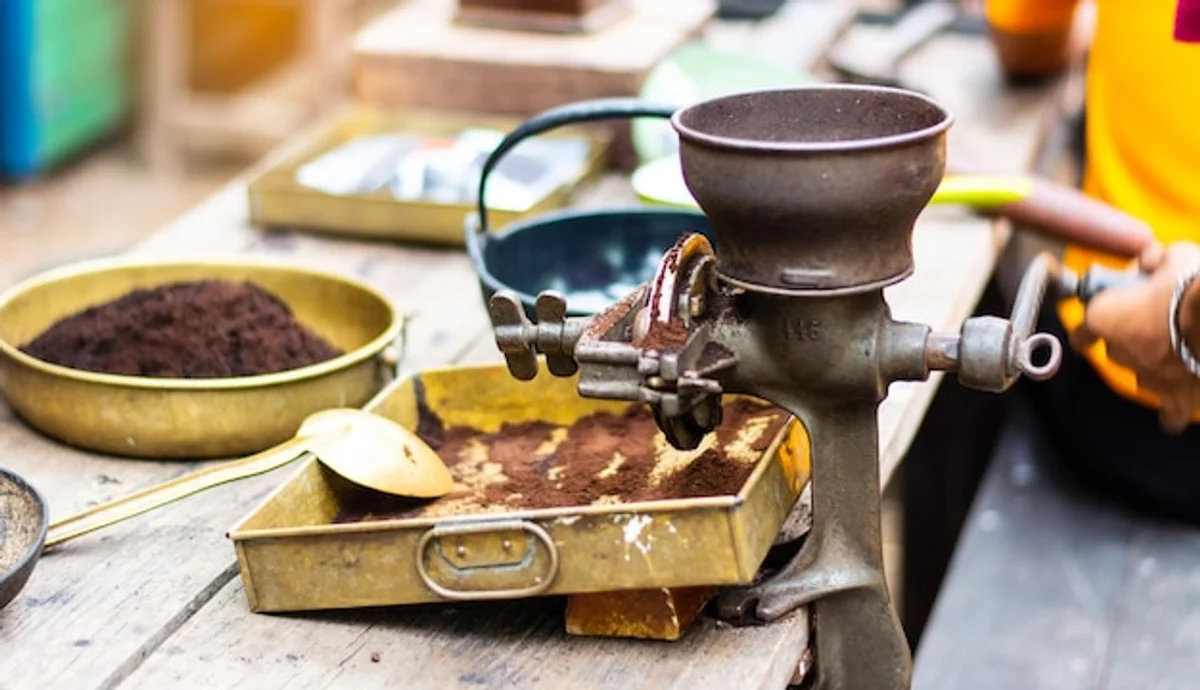 hand polishing stainless pot with coffee beans